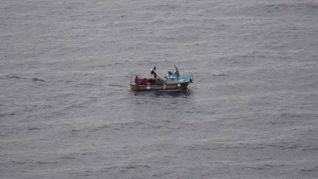 Fishing men in a boat on the mediterranean sea