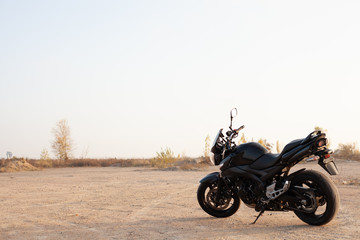 Plakat One black motorcycle in the desert.