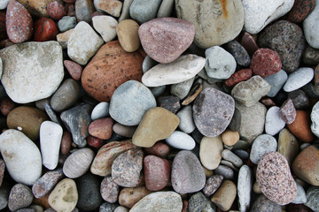smooth colorful pebbles on the beach background