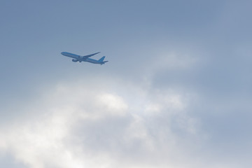 Fototapeta na wymiar a plane flying high in the clouds