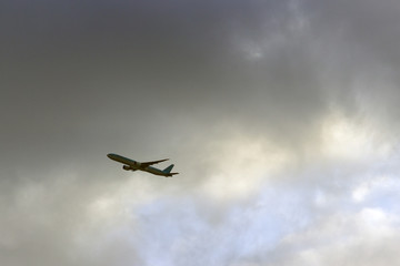 Fototapeta na wymiar a plane flying high in the clouds
