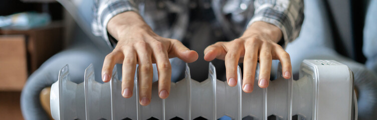 feeling cold, getting warm, hands touching the heater close up