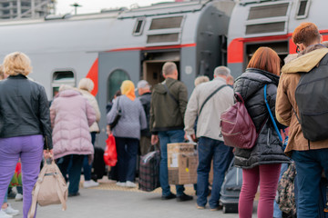 crowd of people waiting for the train on the station platform