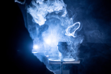 the hookah place with lots of smoke in the dark room