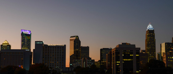 Fototapeta na wymiar View of Charlotte NC skyline at night. The buildings are illuminated on the night sky.