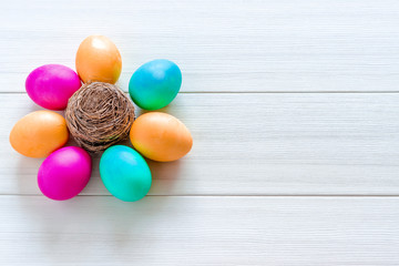 Easter eggs painted in pastel colors on a white wooden background.