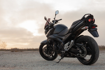 Obraz na płótnie Canvas One black motorcycle in the desert.