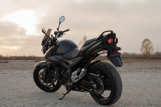 One black motorcycle in the desert. © sergeytay