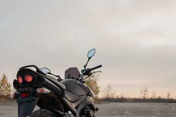 One black motorcycle in the desert.