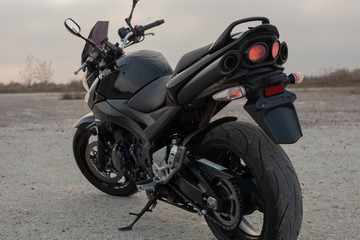 One black motorcycle in the desert.