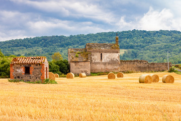 Old church in central Burgundy with heystack, France