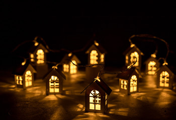 Christmas lights, garland in the form of wooden houses. happy new year mood. preparation for the celebration.