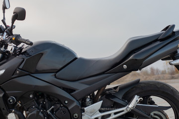 One black motorcycle in the desert.
