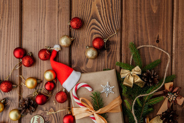 Christmas gift box, food decor and fir tree branch on wooden table. Top view with copy space