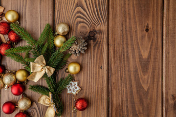 Christmas background with New year toys and fir tree branch on wooden table