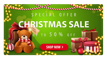 Special offer, Christmas sale, up to 50% off, horizontal green banner with button, garlands and presents with Teddy bear