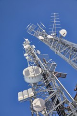 Communication transmitter tower against clear blue sky