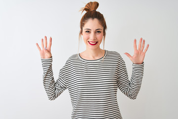 Redhead woman wearing navy striped t-shirt standing over isolated white background showing and...