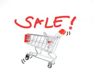 Top view or directly above of sale campaign. Vivid or vibrant red sketch or drawing letters of sale on white background with red trolley or shopping or supermarket cart toy.