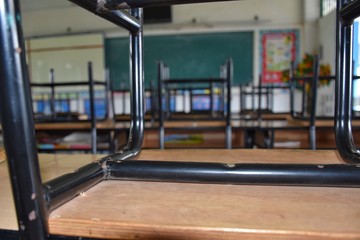 the atmosphere of the classroom in after school time, every student's chair is lifted