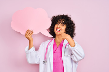 Young arab woman with curly hair holding cloud speech bubble over isolated pink background very happy pointing with hand and finger