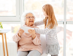 Nice girl helping elderly woman