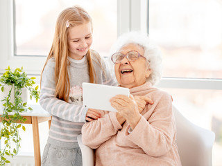 Cute girl helping old lady