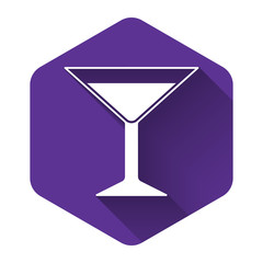 White Martini glass icon isolated with long shadow. Cocktail icon. Wine glass icon. Purple hexagon button. Vector Illustration