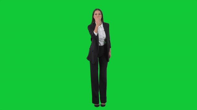 Angry young business woman director showing obscene middle finger gesture at camera. Full length on green screen background. 