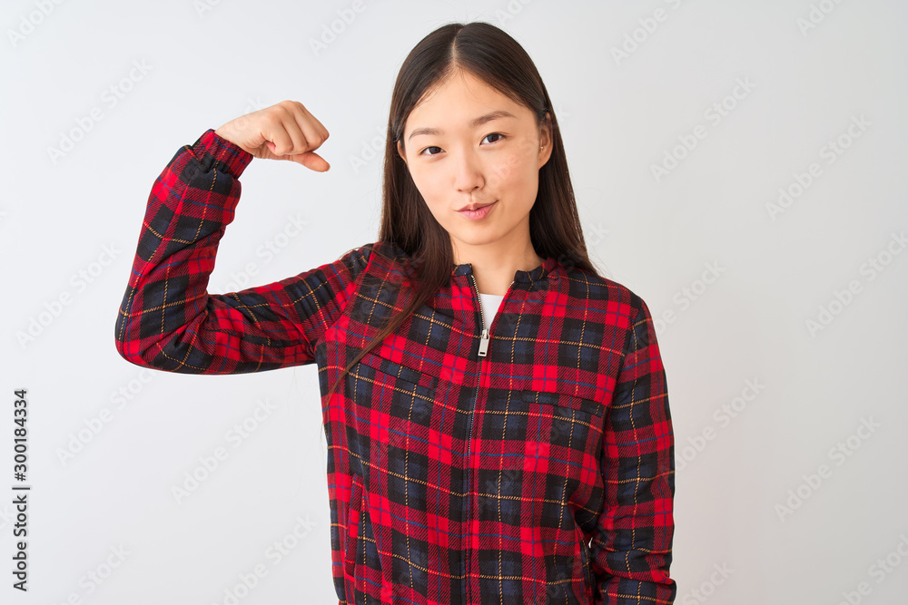 Poster Young chinese woman wearing casual jacket standing over isolated white background Strong person showing arm muscle, confident and proud of power