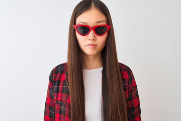 Young chinese woman wearing casual jacket and sunglasses over isolated white background with a...