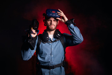 Serious caucasian man with beard looking at camera, while playing virtual game. Hobby, leisure time