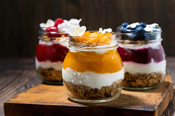 breakfasts in jars with muesli, berry puree and cream