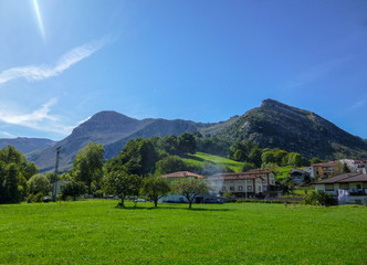 Cantabria landscape with field, montains, river and a small village. Spain