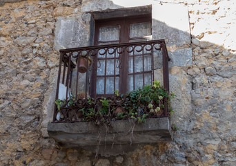 An Old Window with balcony On an old Stone House in Cantabria, Spain .