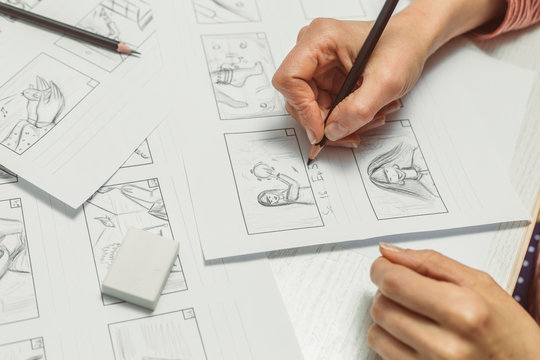 Woman's hand draws a storyboard for a film or cartoon.