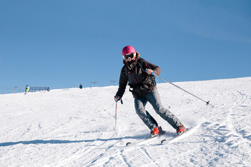 Fototapeta na wymiar Young skier woman posing for the camera on french slopes