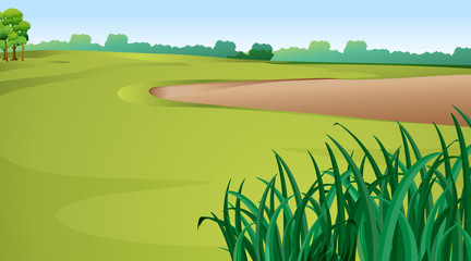 Scene with green grass and sand pit © GraphicsRF