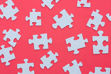 Puzzle pieces on a red background.