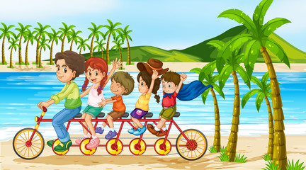 Scene with family riding bike along the ocean
