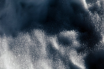 background of shiny frozen snow in a sunny day