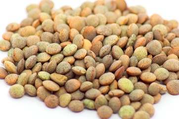Brown lentils detail photo on an isolated white background with strong defocus