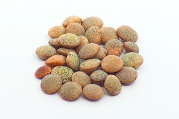 Brown lentils on an isolated white background