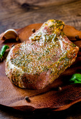 Raw Pork Loin chops marinated meat Steak for bbq on wooden table background