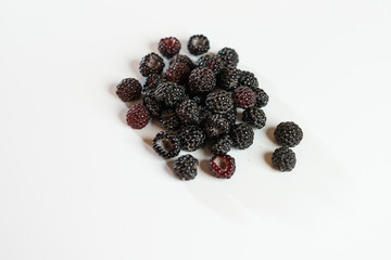 Black raspberry is fragrant and delicious on a white background.