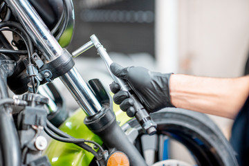 Fototapeta premium Repairing motorcycle at the workshop