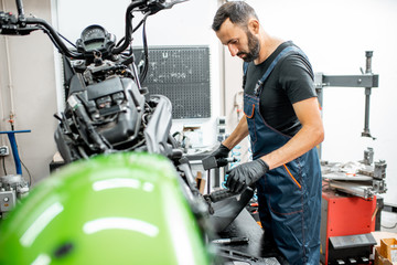 Fototapeta na wymiar Mechanic repairing a motorcycle