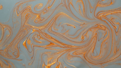 Abstract gold silver sparkling glitter background with mother-of-pearl marble metallic veins.
