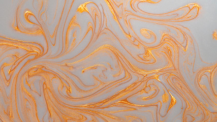Abstract gold sparkling glitter background with mother-of-pearl marble metallic veins.