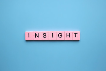 Insight word wooden cubes on blue background